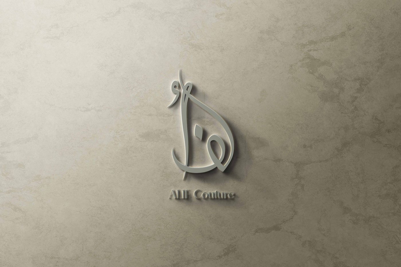 ALIF Couture calligraphic mark embossed on a stone wall