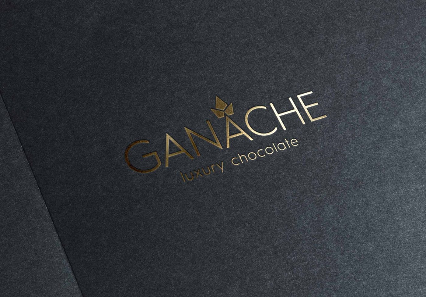 Ganache wordmark in gold foil on black textured stock
